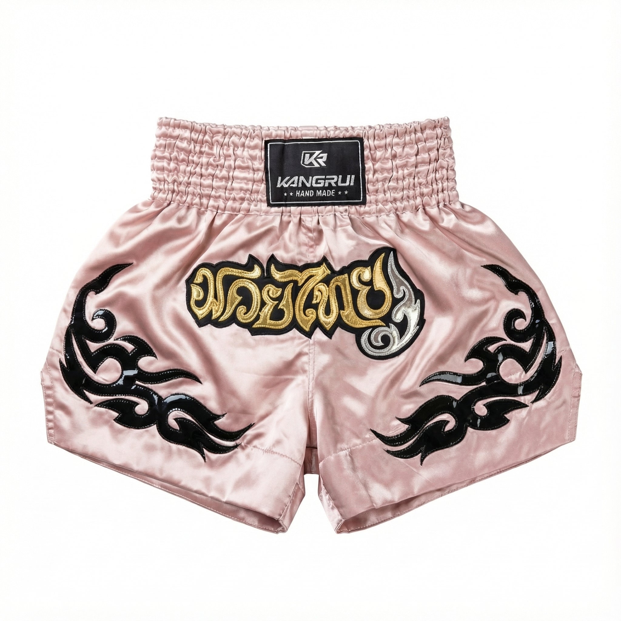 Pink boxing shorts with black tribal designs and gold text on a white background