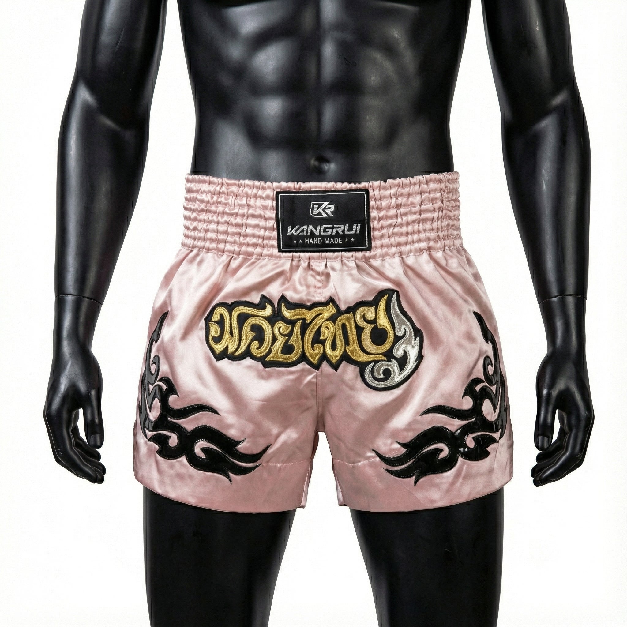 Pink boxing shorts with black designs and a visible brand logo on a mannequin.