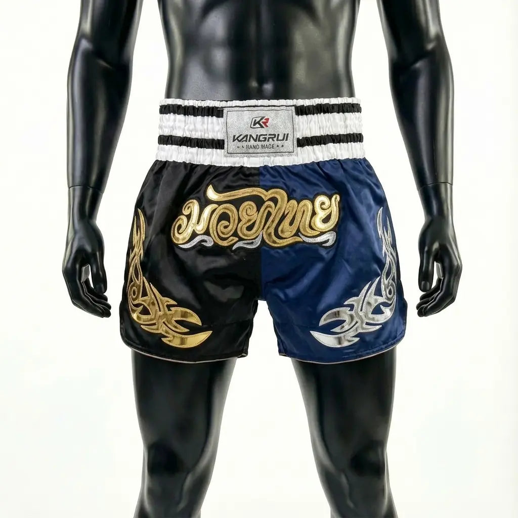 Black and blue boxing shorts with gold and white designs on a mannequin against a white background.