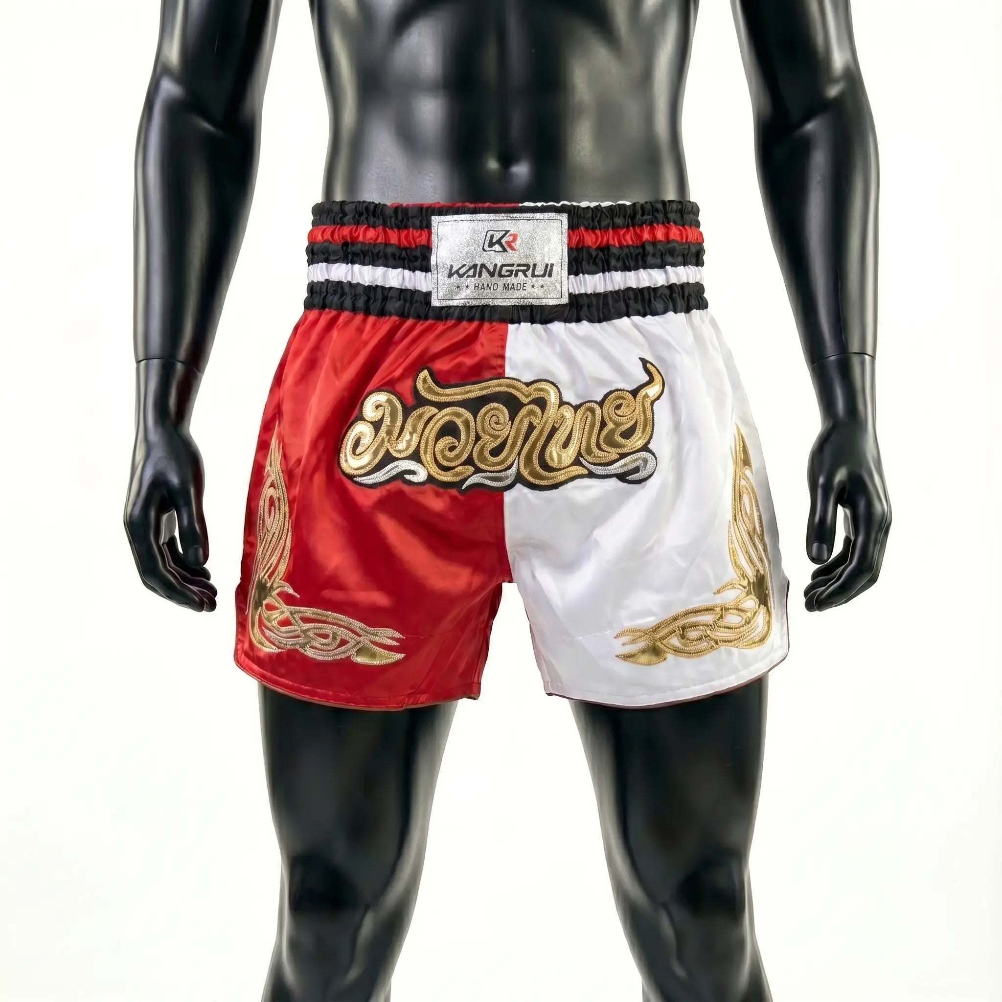 Red and white boxing shorts with gold designs on a mannequin against a white background
