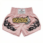 Pink Muay Thai shorts with black designs and a visible brand label on a white background