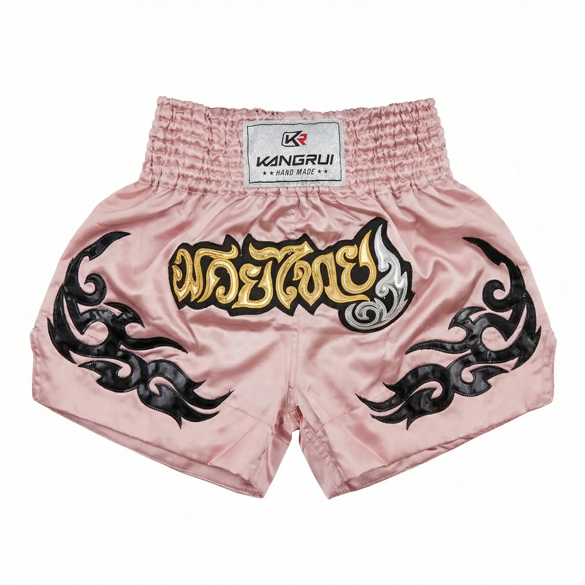 Pink Muay Thai shorts with black designs and a visible brand label on a white background