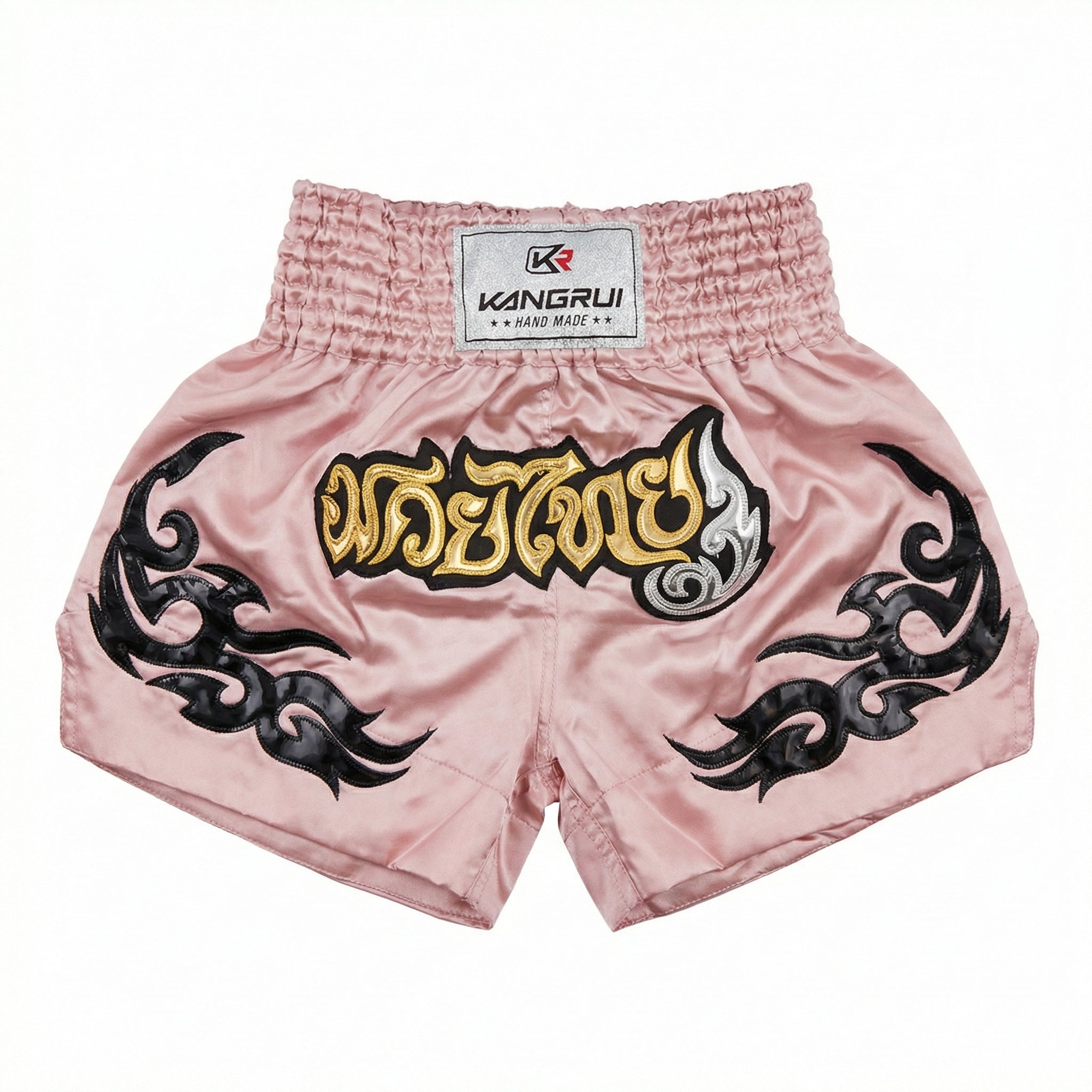 Pink Muay Thai shorts with black designs and a visible brand label on a white background