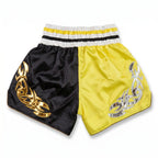 Black and yellow shorts with tribal designs on a white background